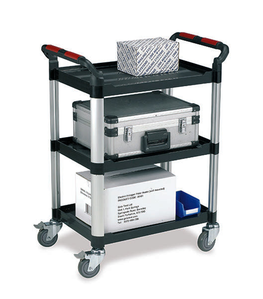 A three-tier utility cart with black plastic shelves, silver metal side rails, and gray caster wheels. The cart is shown empty, with some boxes and a blue bin placed on it as props, against a plain white background.